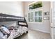 Charming bedroom with a bunk bed and plenty of natural light at 9332 Miami Cir, Port Charlotte, FL 33981