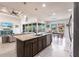Open concept kitchen with a central island and seamless connection to the living and dining areas at 9332 Miami Cir, Port Charlotte, FL 33981