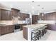 Gourmet kitchen with stainless steel appliances, granite countertops, island with seating, and custom cabinetry at 9332 Miami Cir, Port Charlotte, FL 33981