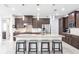 Well-equipped kitchen featuring a central island with barstool seating, modern lighting, and ample counter space at 9332 Miami Cir, Port Charlotte, FL 33981