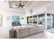Spacious living room with tile floors, high ceilings, comfortable seating, and sliding glass doors to the lanai at 9332 Miami Cir, Port Charlotte, FL 33981