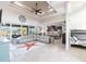 Open-concept living room boasts a decorative ceiling, tile floors, and seamless transition to the kitchen and outdoor space at 9332 Miami Cir, Port Charlotte, FL 33981