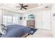 Comfortable main bedroom featuring a tray ceiling, tile floors, and natural light at 9332 Miami Cir, Port Charlotte, FL 33981