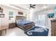 Serene main bedroom featuring a tray ceiling, tile floors, and direct access to the lanai at 9332 Miami Cir, Port Charlotte, FL 33981