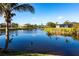 Beautiful water view showcasing the calm lake and surrounding homes and landscaping at 9332 Miami Cir, Port Charlotte, FL 33981