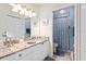 Bathroom featuring granite counters, dual sinks, and patterned shower at 9630 Club South Cir # 6208, Sarasota, FL 34238