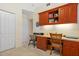 Bedroom featuring a built-in desk, upper cabinets for storage, and a neutral color scheme at 9630 Club South Cir # 6208, Sarasota, FL 34238