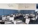 Inviting dining area with tables set for service, featuring comfortable seating and decorative wall art at 9630 Club South Cir # 6208, Sarasota, FL 34238
