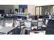 Spacious dining area featuring tables with white clothed chairs and buffet stations in the background at 9630 Club South Cir # 6208, Sarasota, FL 34238