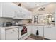 Clean and functional kitchen with white cabinets, modern appliances, and ample counter space at 9630 Club South Cir # 6208, Sarasota, FL 34238