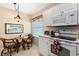 Kitchen with white cabinetry, stainless steel appliances and breakfast nook at 9630 Club South Cir # 6208, Sarasota, FL 34238