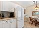 Bright kitchen features white cabinets, modern appliances, and adjacent dining nook at 9630 Club South Cir # 6208, Sarasota, FL 34238