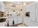 Well-lit kitchen featuring white cabinetry, modern appliances, and convenient access to the living spaces at 9630 Club South Cir # 6208, Sarasota, FL 34238
