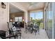 Comfortable lanai connecting to the living area, with seating and panoramic views of the surrounding landscape at 9630 Club South Cir # 6208, Sarasota, FL 34238