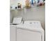 White laundry room with white washer and dryer and overhead storage shelf at 9630 Club South Cir # 6208, Sarasota, FL 34238