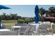Relaxing outdoor patio with tables and chairs, offering views of the golf course and clear blue skies at 9630 Club South Cir # 6208, Sarasota, FL 34238
