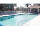 Community pool surrounded by lounge chairs and lush landscaping for relaxation at 9630 Club South Cir # 6208, Sarasota, FL 34238