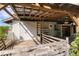 Covered back porch featuring wood decking and exposed beams, providing a cozy retreat at 1004 12Th W Ave, Palmetto, FL 34221