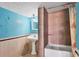 Bathroom featuring tile shower, tub and a pedestal sink against a blue painted wall at 1004 12Th W Ave, Palmetto, FL 34221