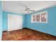Bedroom featuring a window, closet, and hard-surface flooring and eye-catching blue walls at 1004 12Th W Ave, Palmetto, FL 34221