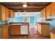 Bright kitchen with wood cabinets, unique countertops, and terra cotta tile flooring at 1004 12Th W Ave, Palmetto, FL 34221
