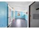 Living room with blue painted walls featuring hard surface floors and a pair of French doors at 1004 12Th W Ave, Palmetto, FL 34221