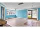 Spacious living room featuring a ceiling fan, tile flooring, and large windows at 1004 12Th W Ave, Palmetto, FL 34221
