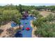 Aerial view of a colorful playground set in a park with mature trees at 1004 12Th W Ave, Palmetto, FL 34221