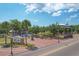 Scenic view of Sutton Park with its lush greenery, playground, and charming gazebo at 1004 12Th W Ave, Palmetto, FL 34221