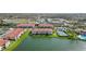Community aerial view showcasing buildings with terracotta roofs around a large, picturesque lake at 1005 Villagio Cir # 106, Sarasota, FL 34237