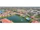 Aerial view of Villagio community with a lake, swimming pool, tennis courts and multiple condo buildings at 1005 Villagio Cir # 106, Sarasota, FL 34237