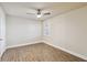 Bright bedroom featuring laminate floors, ceiling fan, and natural light at 1005 Villagio Cir # 106, Sarasota, FL 34237