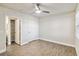Bedroom boasts laminate floors, a ceiling fan, and a walk-in closet with shelving at 1005 Villagio Cir # 106, Sarasota, FL 34237