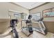 Cozy exercise room equipped with modern treadmill, elliptical, and stationary bike at 1005 Villagio Cir # 106, Sarasota, FL 34237