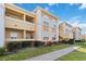Beautiful condo building with well-manicured lawn, mature landscaping, and a sunny exterior at 1005 Villagio Cir # 106, Sarasota, FL 34237