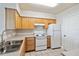 Kitchen with white appliances, wood cabinets, and neutral countertops at 1005 Villagio Cir # 106, Sarasota, FL 34237