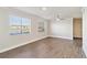 Bright living room with wood-look flooring, ceiling fan and a view of the lake at 1005 Villagio Cir # 106, Sarasota, FL 34237