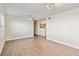 Open-concept living room with wood-look flooring and views into the kitchen at 1005 Villagio Cir # 106, Sarasota, FL 34237
