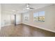 Bright living room with wood-look flooring, ceiling fan and sliding glass door to lanai at 1005 Villagio Cir # 106, Sarasota, FL 34237
