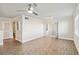 Living room features wood-look flooring, ceiling fan and view into the bathroom at 1005 Villagio Cir # 106, Sarasota, FL 34237