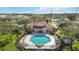 Aerial view of community pool with octagonal shape, lounge chairs and covered pavilion with red tile roof at 1005 Villagio Cir # 106, Sarasota, FL 34237