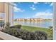 Scenic view of the lake from the property, framed by lush greenery and a clear blue sky at 1005 Villagio Cir # 106, Sarasota, FL 34237