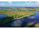 Beautiful aerial view showcases a golf community with waterfront and natural landscaping at 10509 Winding Stream Way, Bradenton, FL 34212