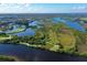 Scenic aerial view showcases a golf community with natural landscaping and a long, winding waterway at 10509 Winding Stream Way, Bradenton, FL 34212