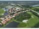 Stunning aerial view showcases a lovely golf community with waterfront homes and lush landscaping at 10509 Winding Stream Way, Bradenton, FL 34212