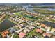 An aerial view of a beautiful neighborhood, showcasing waterfront properties and a golf course at 10509 Winding Stream Way, Bradenton, FL 34212