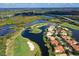 Breathtaking aerial shot of waterfront homes nestled along a golf course with a bridge and waterway at 10509 Winding Stream Way, Bradenton, FL 34212