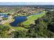 Aerial view showcases a beautiful golf community with ponds, lush landscaping, and serene waterways at 10509 Winding Stream Way, Bradenton, FL 34212