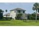 Spacious backyard featuring lush lawn, privacy fence, and mature tropical landscaping at 10509 Winding Stream Way, Bradenton, FL 34212