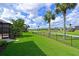 Expansive green backyard with a black fence overlooking a serene golf course at 10509 Winding Stream Way, Bradenton, FL 34212